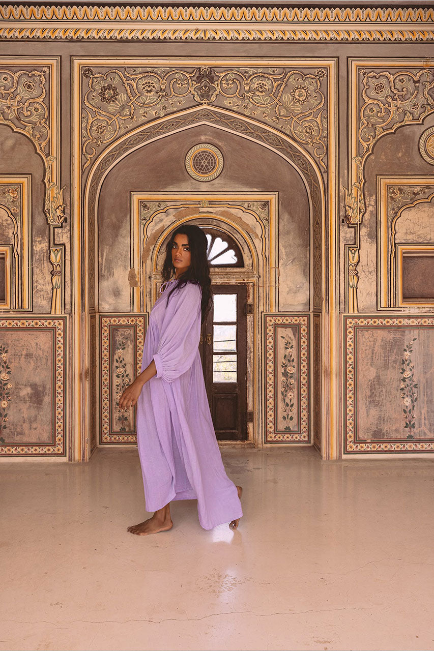 Daughters of India Kyra Maxi Dress in Lilac Gauze — side view walking in palace, flowing skirt and billowed sleeves