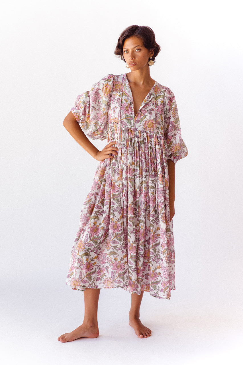 Daughters of India Kyra Midi Dress in Fuchsia Bloom — studio full length, V-neckline, hand in pocket, flowing skirt