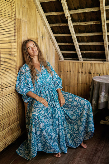 Daughters of India Kyra Midi Dress in Ocean Blue — seated in bamboo beach hut, hand screen print cotton