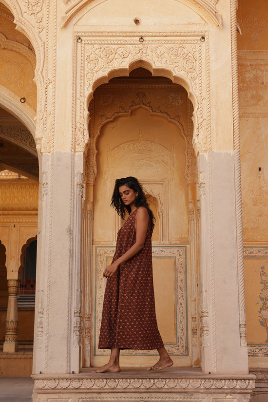 Sundress Midi Almond — model in heritage courtyard setting, full length portrait, flowing almond sundress midi, traditional Indian architecture backdrop, hand block print cotton, Jaipur artisan | Daughters of India