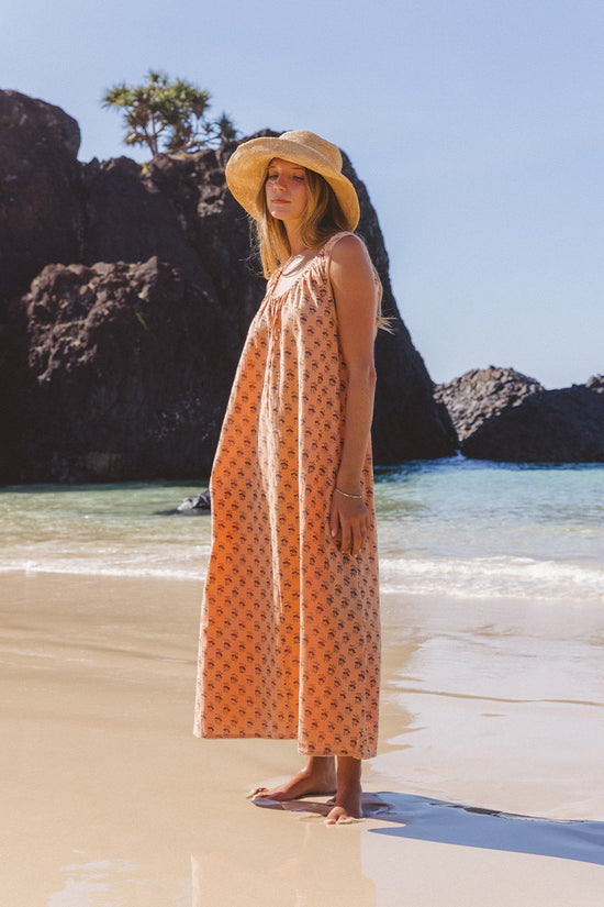 Sundress Midi Peach — studio back view, model showing reverse of dress, sleeveless open back silhouette, tie-gather neckline detail, hand block print peach floral cotton midi, artisan Jaipur India | Daughters of India